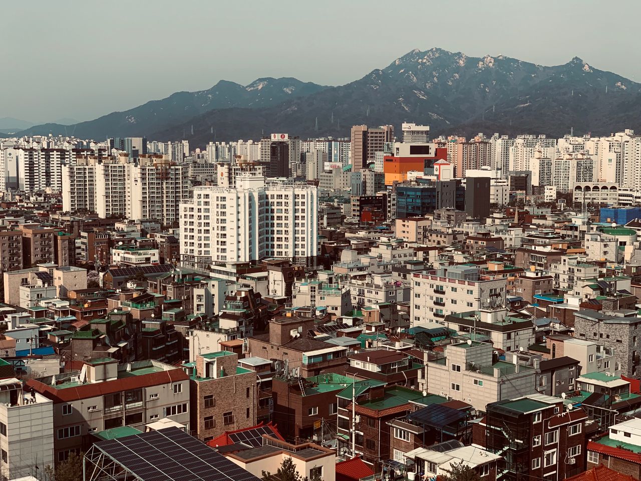 Crafting Captivating Headlines: Your awesome post title goes here Aerial cityscape of Seoul with mountains, showcasing the urban density and architecture.